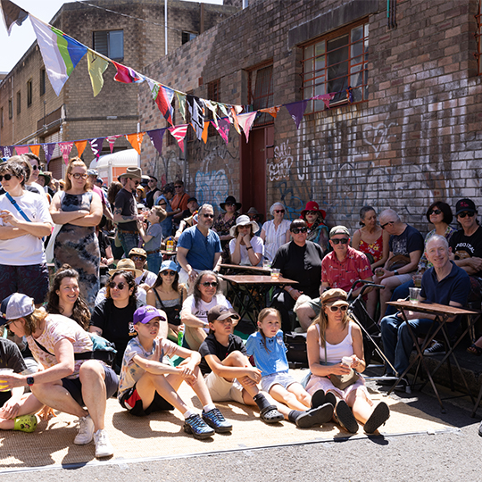 a group of people sitting in a laneway